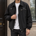 Man wearing a black utility jacket with silver hardware