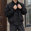 Man wearing a black stand collar jacket