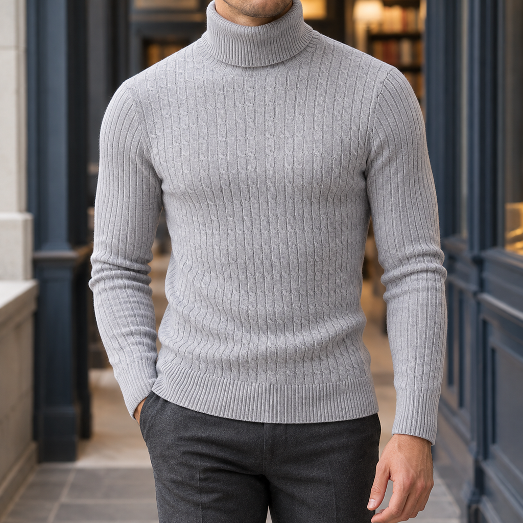 Man wearing a light gray cable knit roll neck jumper