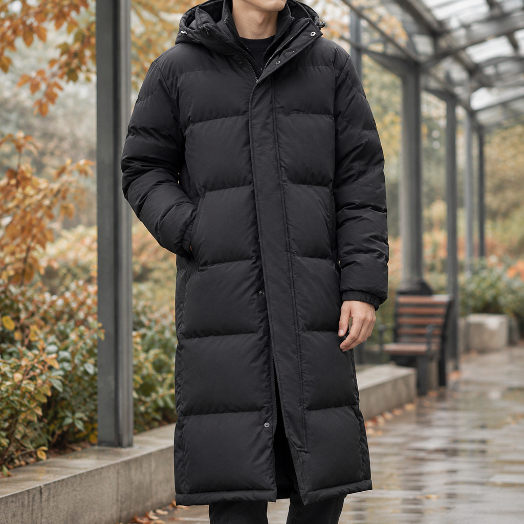 Man wearing a black ankle-length puffer coat with hood