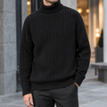 Man wearing a black ribbed roll neck jumper