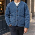 Men's blue denim jacket with quilted lining and patch pockets